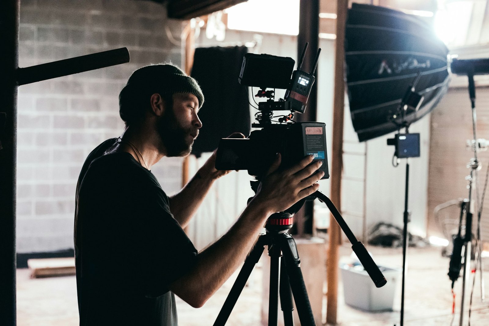 Video creator filming with a professional camera in a studio